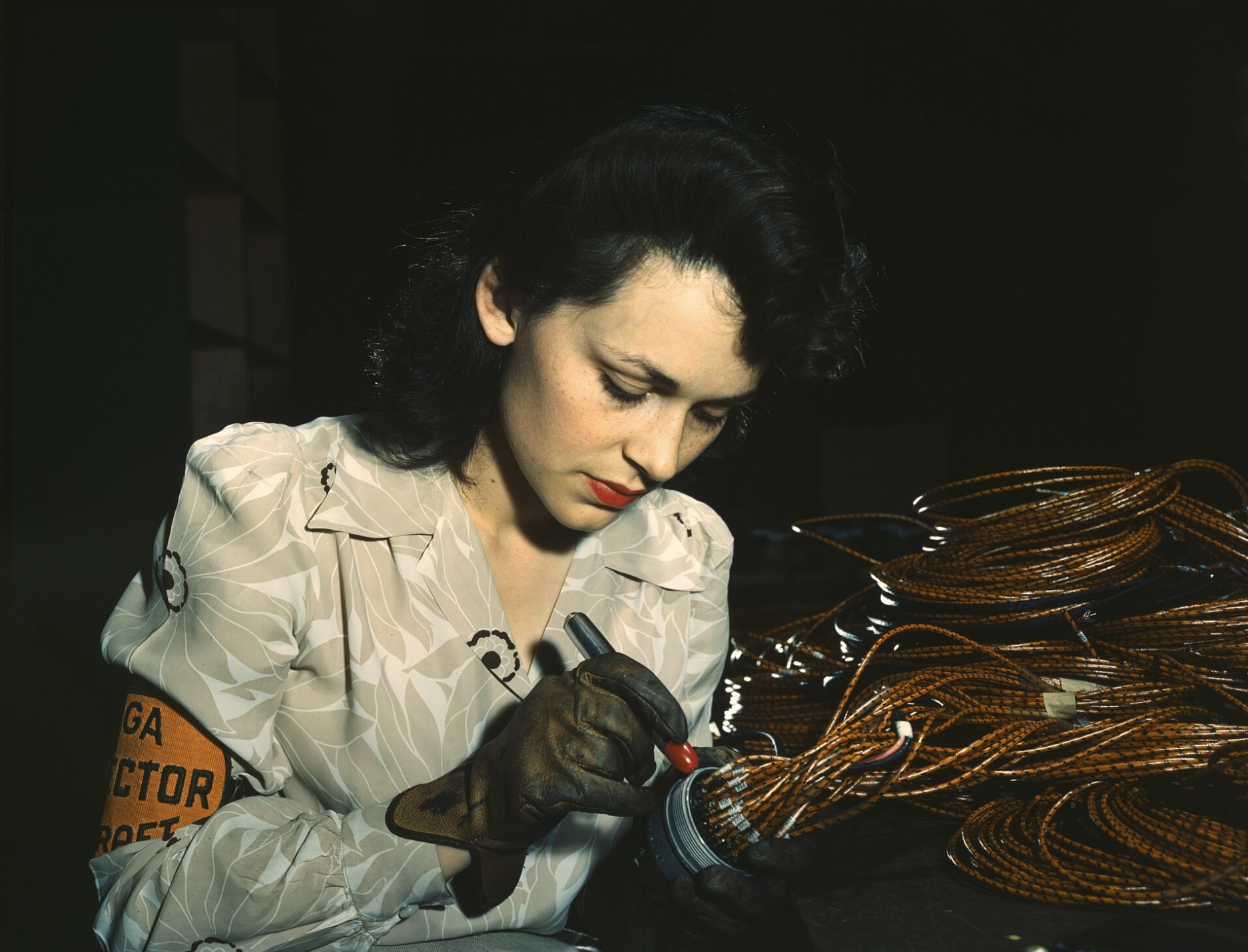 Woman aircraft worker checking assemblies in California 